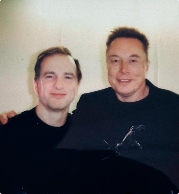 Peter Arnell and Elon Musk posing for a selfie