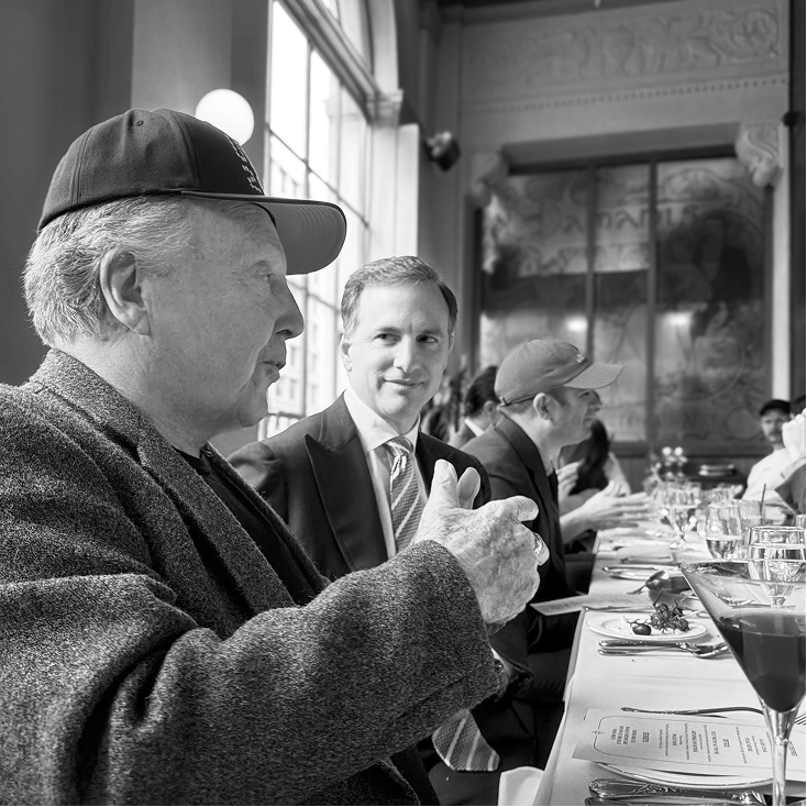 Peter Arnell speaking at a formal dinner table