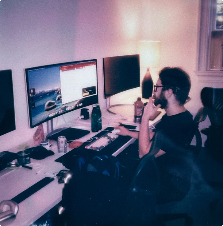 Engineer working at a dual-monitor home office desk